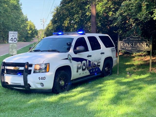 Picture of Oakland Police Car and Oakland speed sign